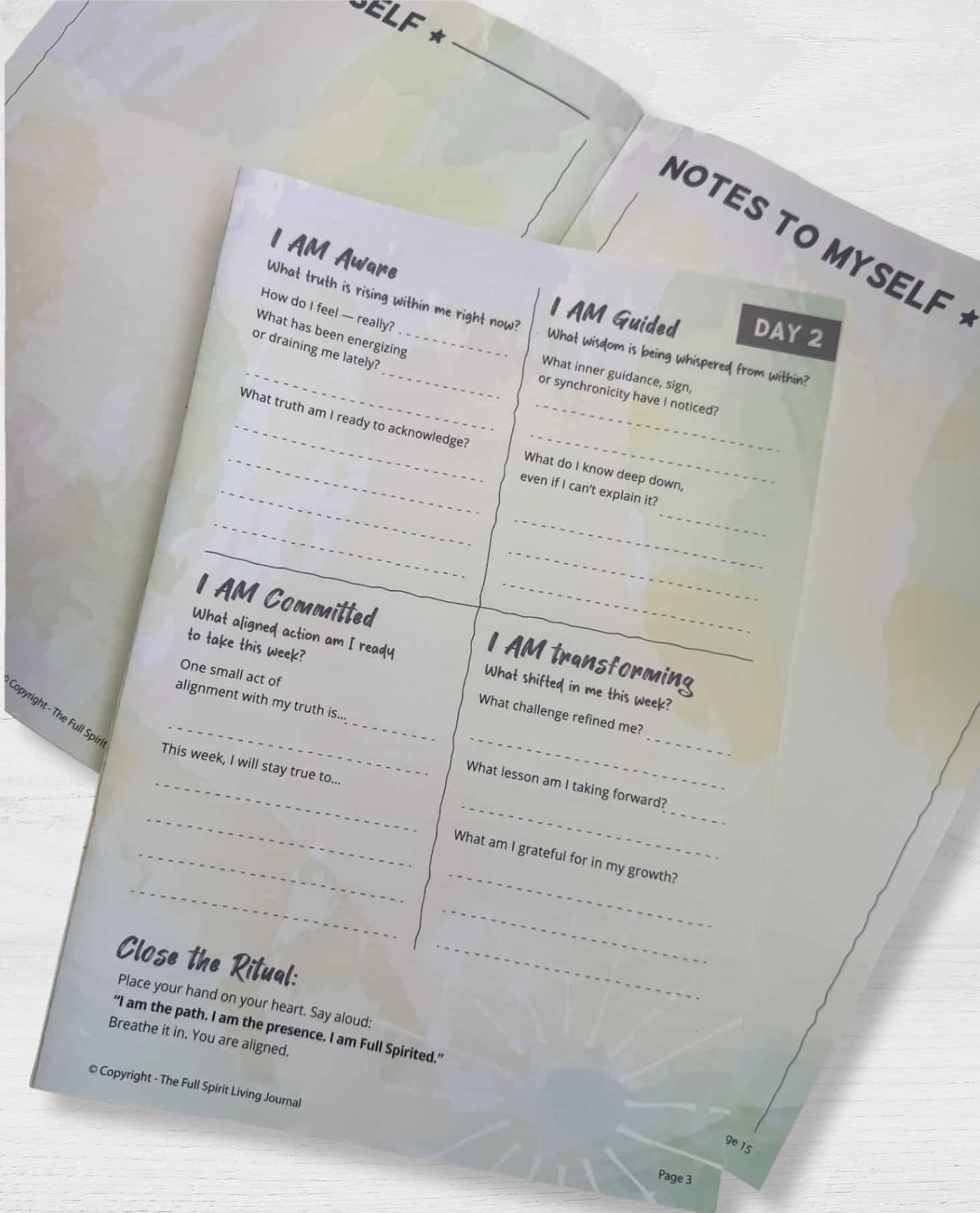 Open pages of the Full Spirit Living Journal showing Day 2 prompts including I Am Aware, I Am Guided, I Am Committed, and I Am Transforming